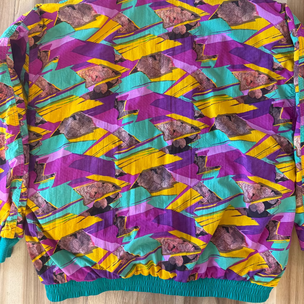 Colorful patterned jacket on a wooden surface