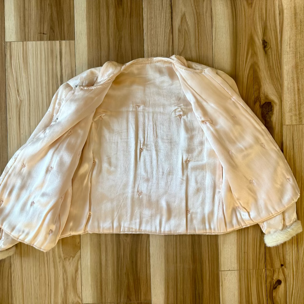 pink silk jacket on wood floor background