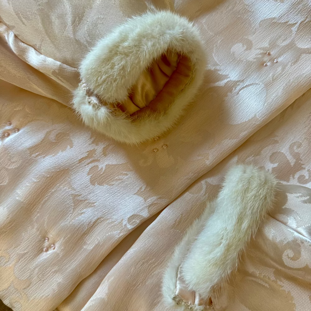 mink fur cuffs against light pink silk jacket